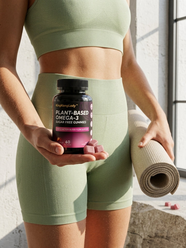 A woman holding KingKongLady plant-based omega-3 gummies and a rolled yoga mat.